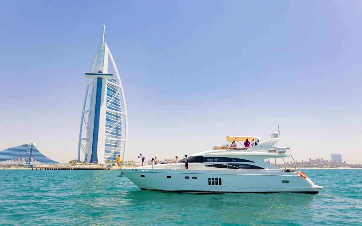 A private yacht on the water in front of the Burj Al Arab on the Dubai coast